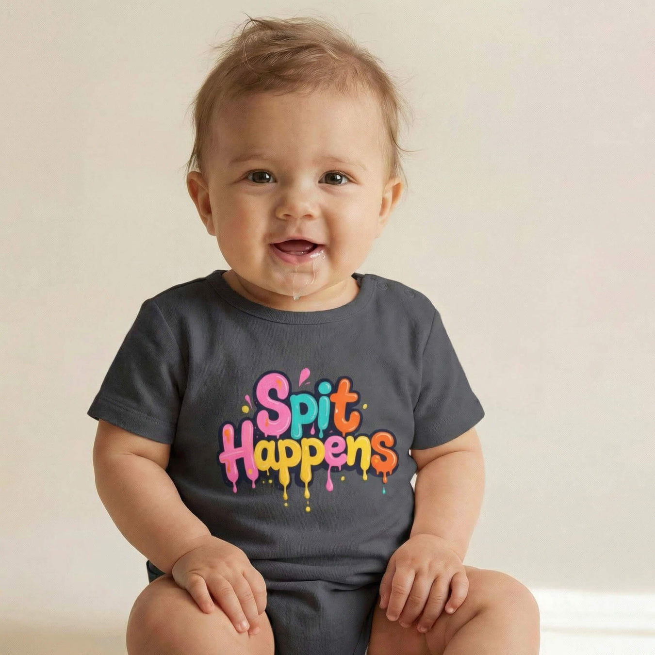 Baby wearing a funny “Spit Happens” milestone onesie while spitting for capturing and sharing as a playful baby special milestone moments on social media 